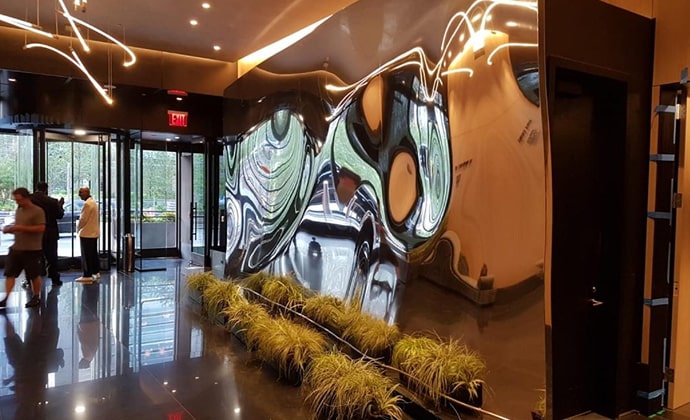 Aluminium sculpture 'Based Upon' located in the Equinox Hotel at Hudson Yards, New York, showcasing smooth, mirror-like surfaces that reflect the surrounding environment with clarity.