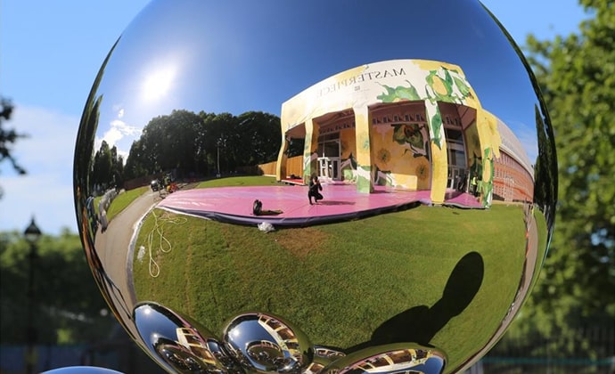Sculpture 'We Are Water' by Patrick Hurst, featuring smooth, reflective stainless steel surfaces with flowing, liquid-like forms capturing the essence of water.